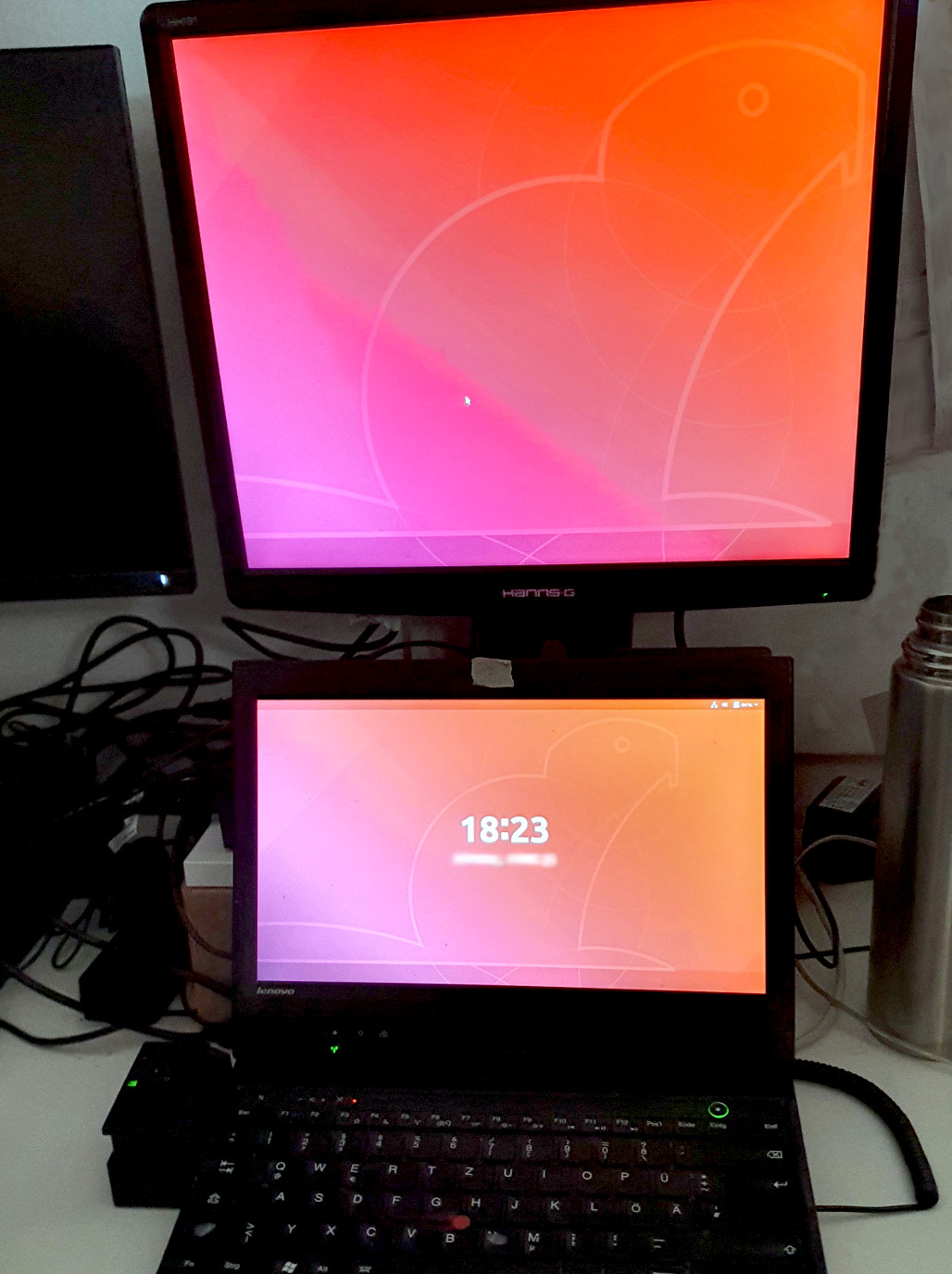 A picture of my Hanns-G monitor and old private laptop with classic docking station.